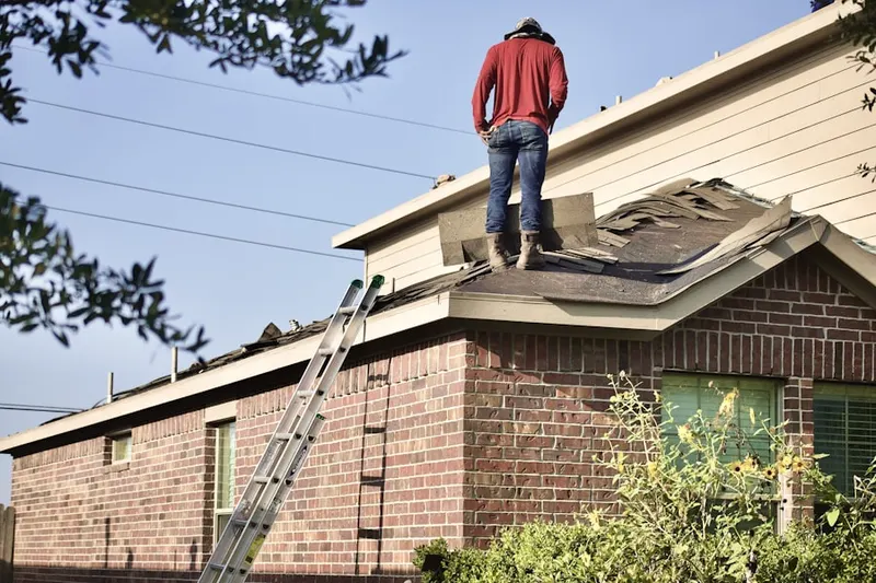 Professional roofer working on a residential roof in Stark Corners